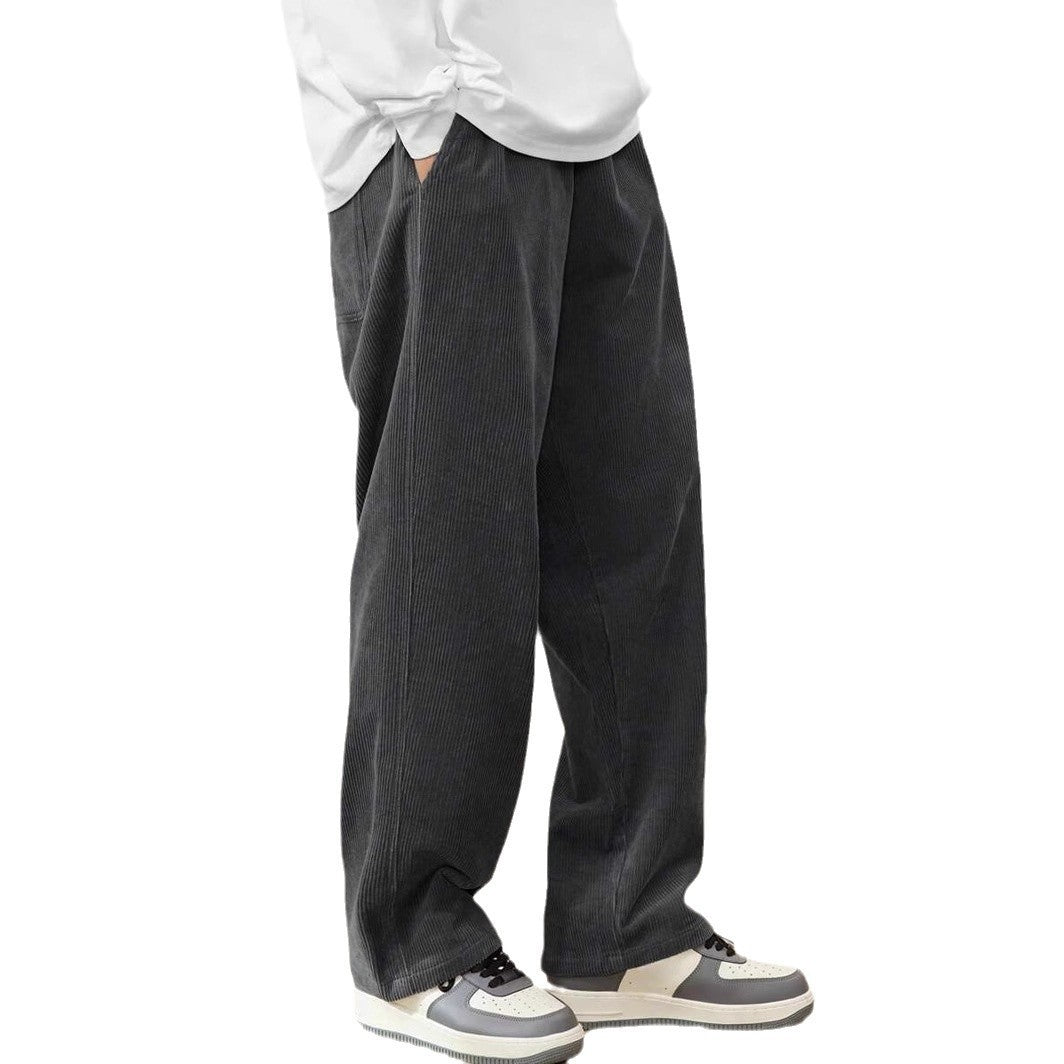 Person wearing dark gray wide-leg pants with a white shirt on a white background