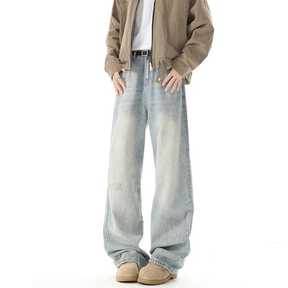 Person wearing light blue jeans and a beige jacket on a white background