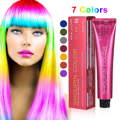 Woman with colorful hair next to Shoupin Color hair dye packaging and color chart.