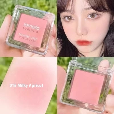L'omelo blush compact with a close-up of a person wearing it, showing color on skin.