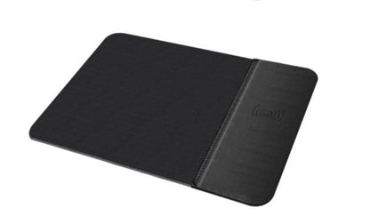A black rubber mouse pad with a wireless charging feature on the right side, where a smartphone is being charged.