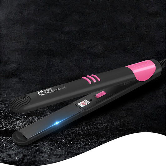 Black hair straightener with pink accents on a dark textured background