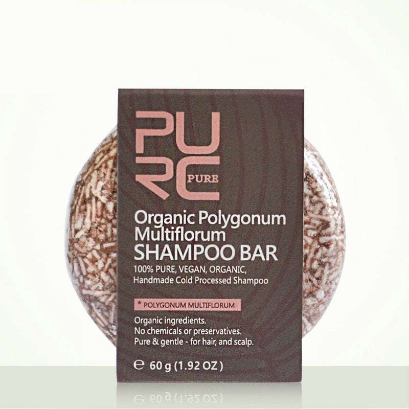 Shampoo bar with packaging labeled 'PURE Organic Polygonum Multiflorum Shampoo Bar' on a white background.