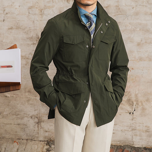 Person wearing a green jacket with a brick wall background