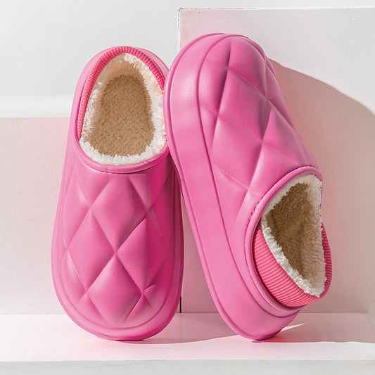 A pair of pink thermal cotton slippers with a round toe cover and flat heel design, placed side by side on a light background.