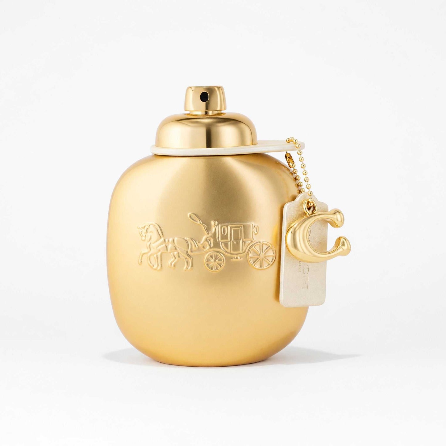 Gold perfume spray bottle with round cap and hanging tag