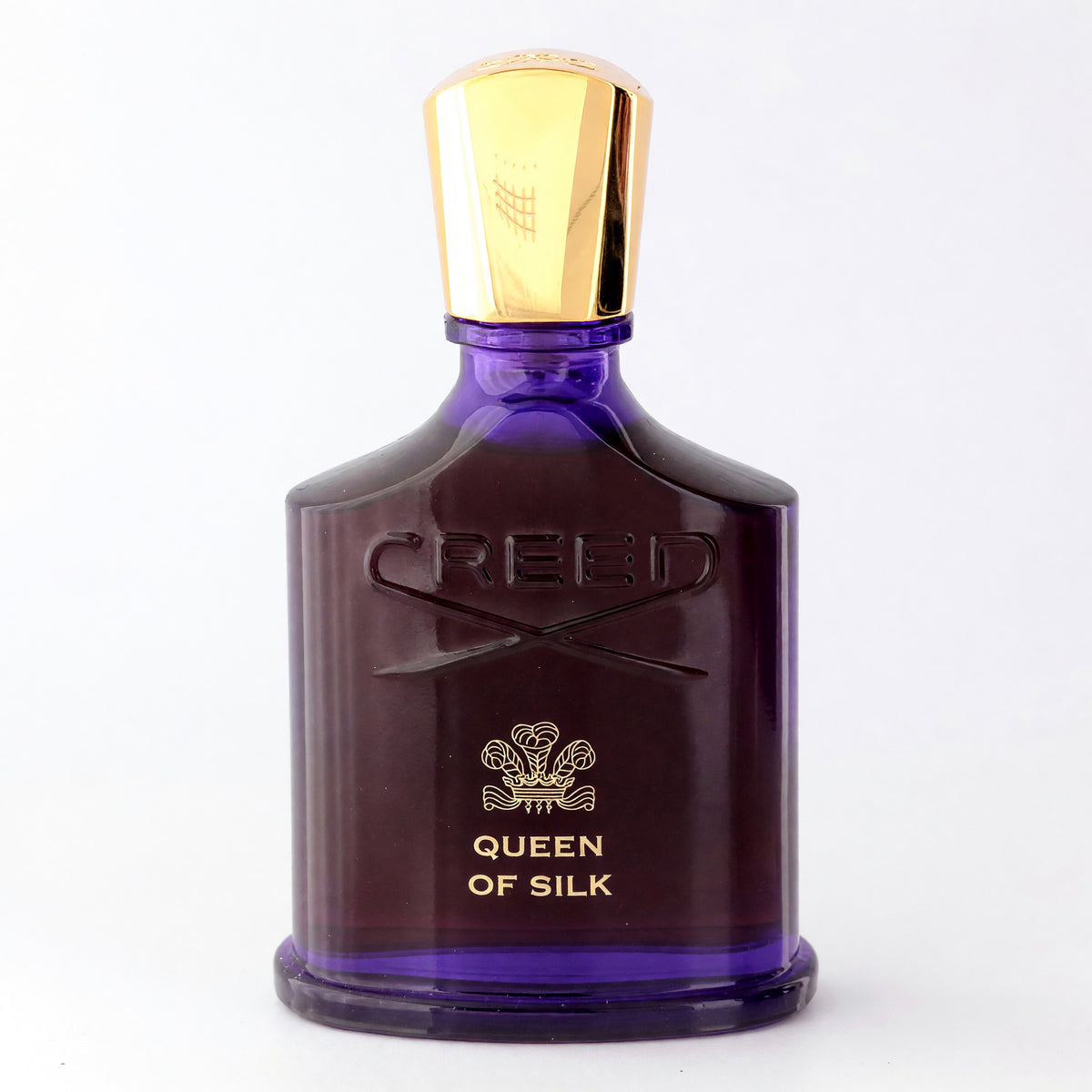 Creed Queen of Silk eau de parfum spray in a dark purple bottle with a gold cap
