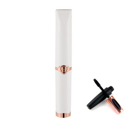 White and rose gold eyelash curler on a white background