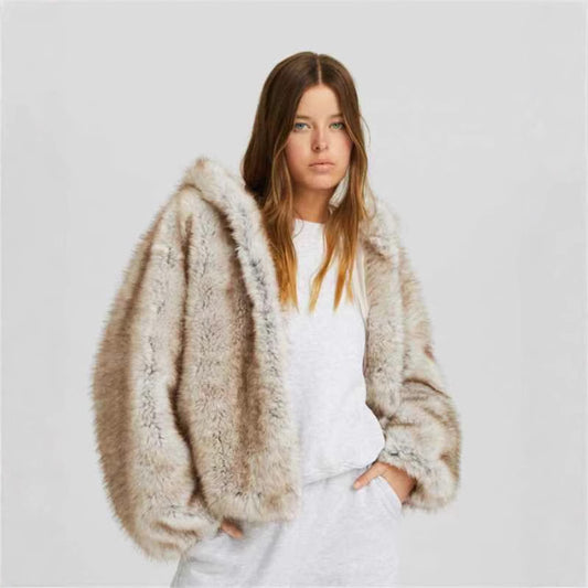 Woman wearing a fluffy beige coat against a plain background