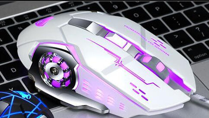 White gaming mouse with purple accents on a laptop keyboard