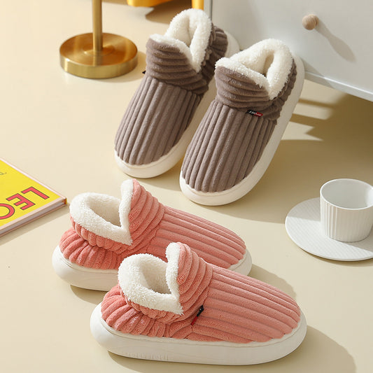 A pair of pink women's home slippers with thick soles and white lining, displayed on a light background.